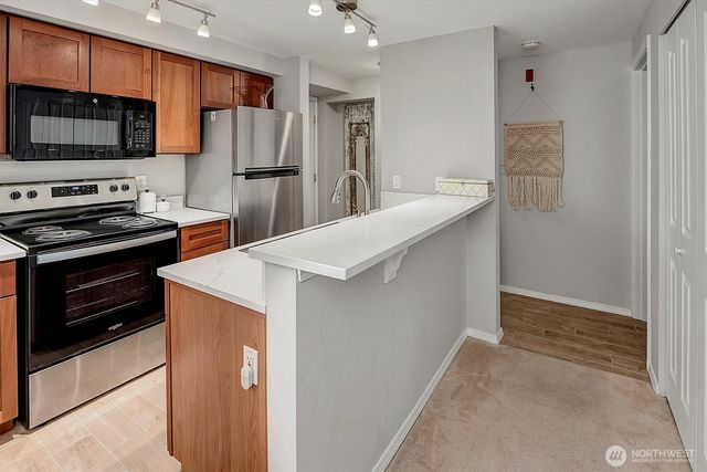 a kitchen with stainless steel appliances a refrigerator and a stove top oven