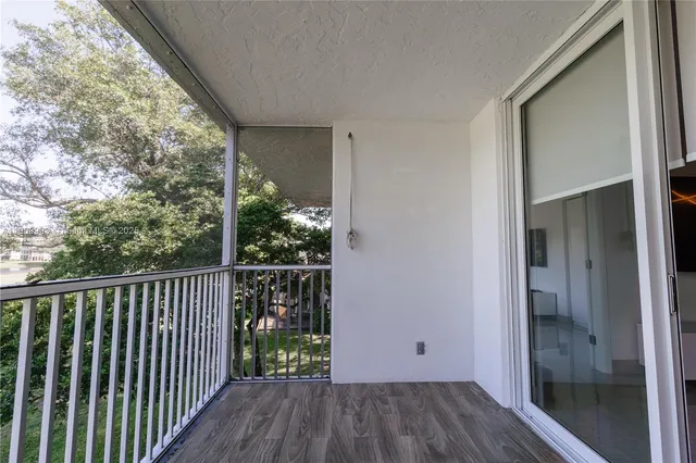 a view of balcony with wooden floor