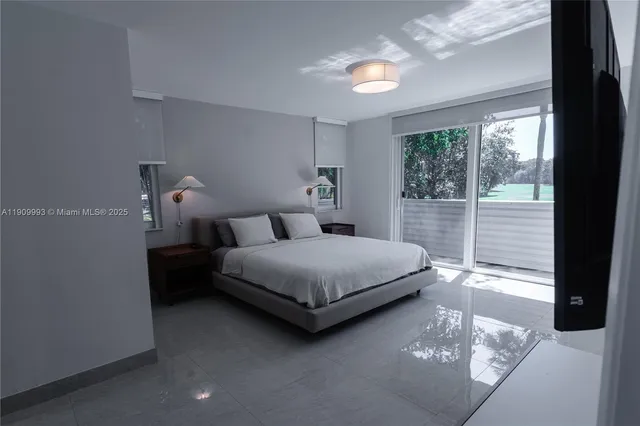 a bedroom with a bed lamp and window