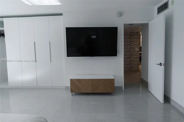 a living room with a flat screen tv and a fireplace