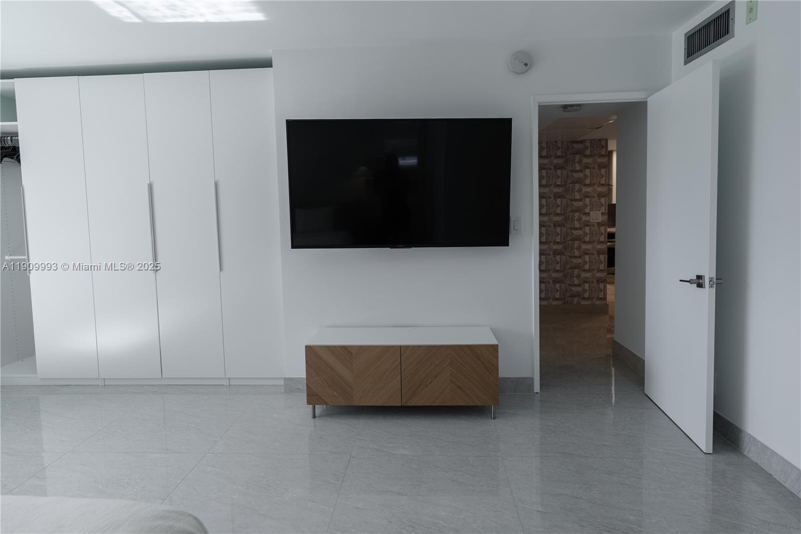 4017 North Cypress Drive, Unit 201 Pompano Beach, FL 33069 - Photo 20 of 44 a living room with a flat screen tv and a fireplace