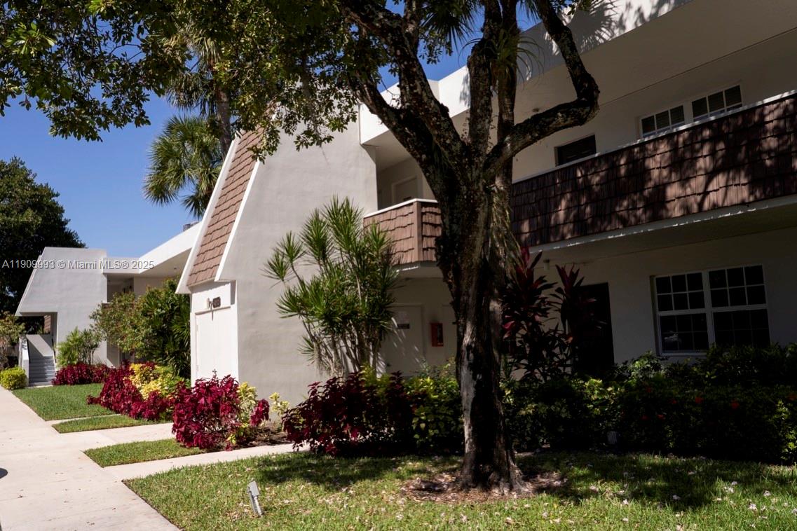 4017 North Cypress Drive, Unit 201 Pompano Beach, FL 33069 - Photo 2 of 44 a tree in front of a house with a yard