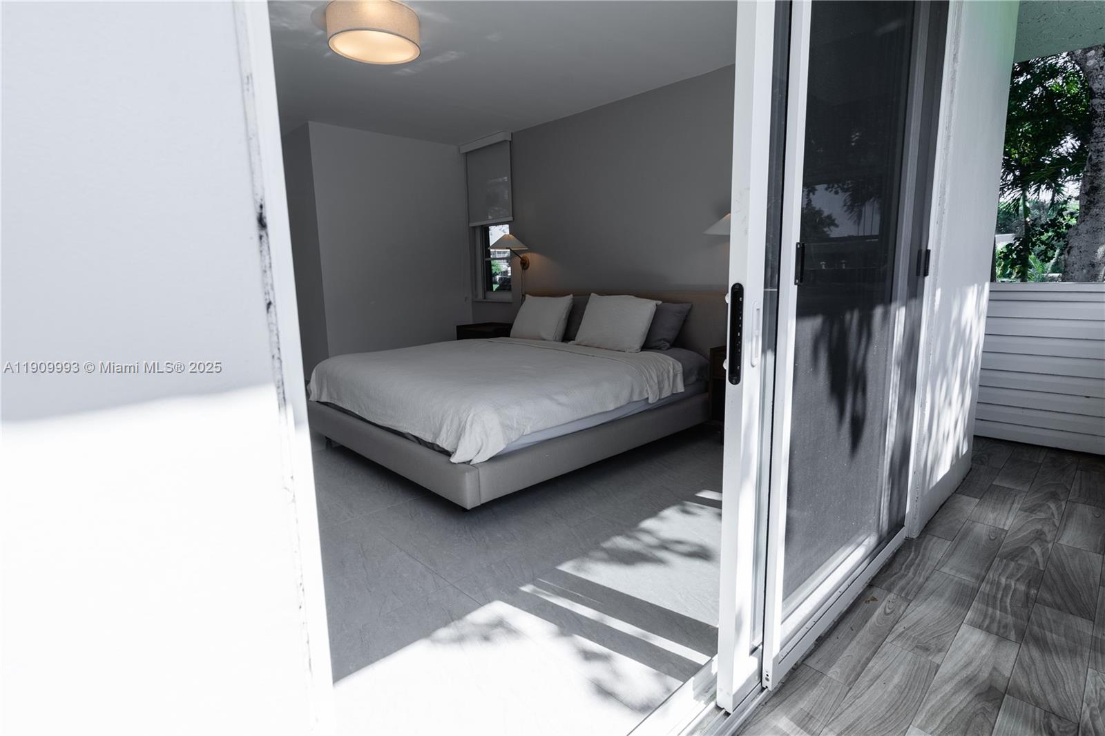 4017 North Cypress Drive, Unit 201 Pompano Beach, FL 33069 - Photo 23 of 44 a bedroom with a bed and a window