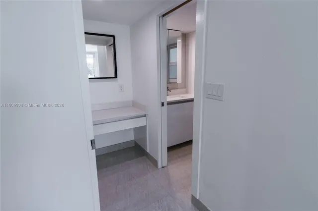 a view of a room that has a bed in it