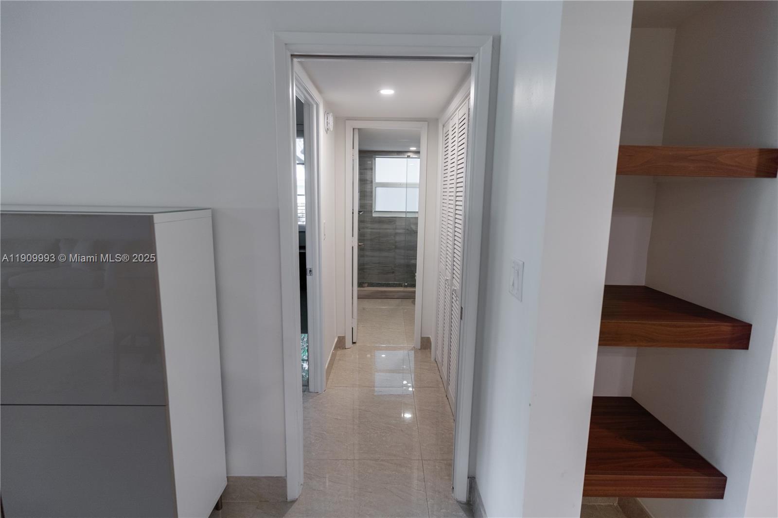 4017 North Cypress Drive, Unit 201 Pompano Beach, FL 33069 - Photo 30 of 44 a view of a hallway with wooden floor