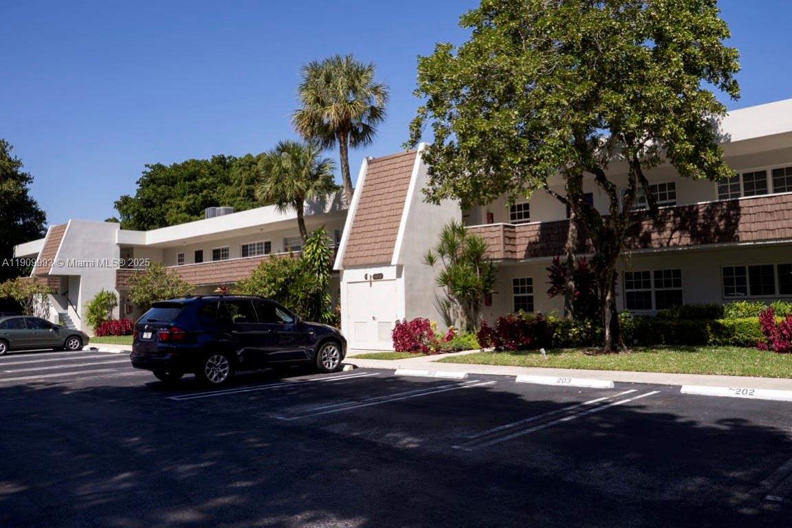 4017 North Cypress Drive, Unit 201 Pompano Beach, FL 33069 - Photo 3 of 44 a car parked in front of a house