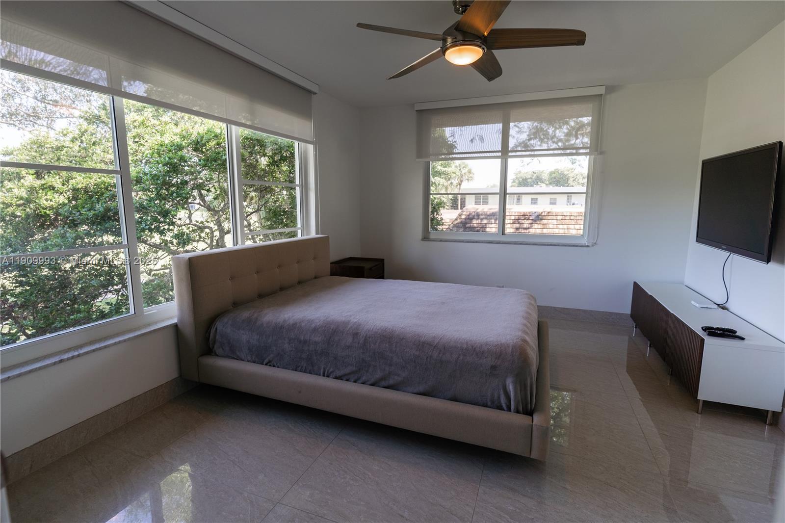 4017 North Cypress Drive, Unit 201 Pompano Beach, FL 33069 - Photo 38 of 44 a bed sitting in a bedroom next to a window