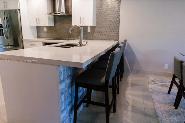 a kitchen with a table chairs and a refrigerator