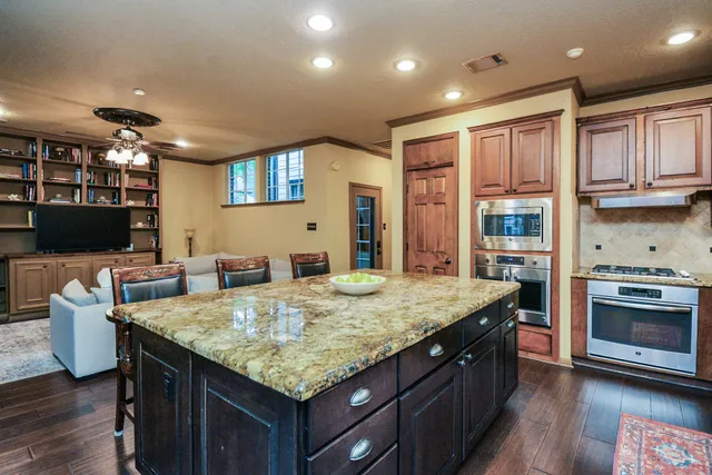 a kitchen with center island and stainless steel appliances