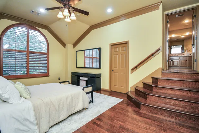 a spacious bedroom with a bed and a large window