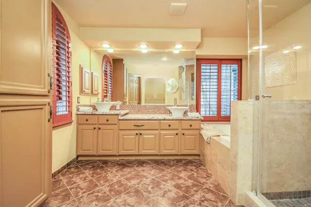 a large bathroom with a sink and a large mirror