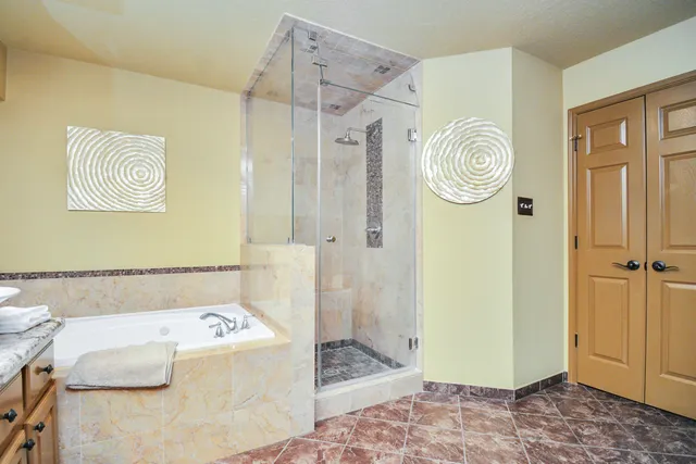 a bathroom with a bathtub and a shower