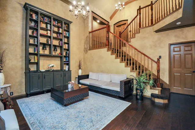 a living room with furniture and wooden floor