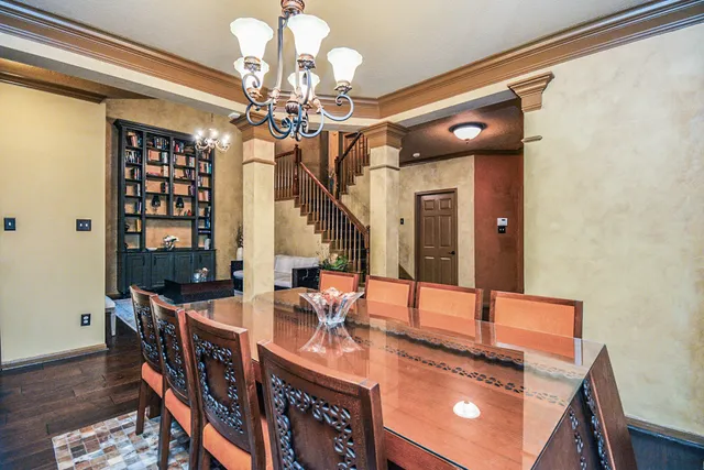 a view of a dining room with furniture and chandelier
