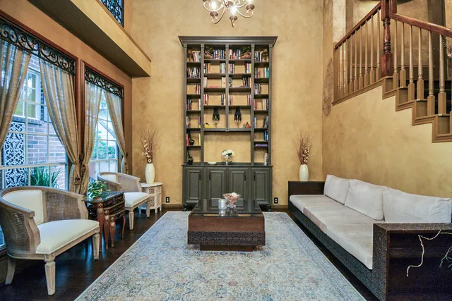 a living room with furniture and a potted plant