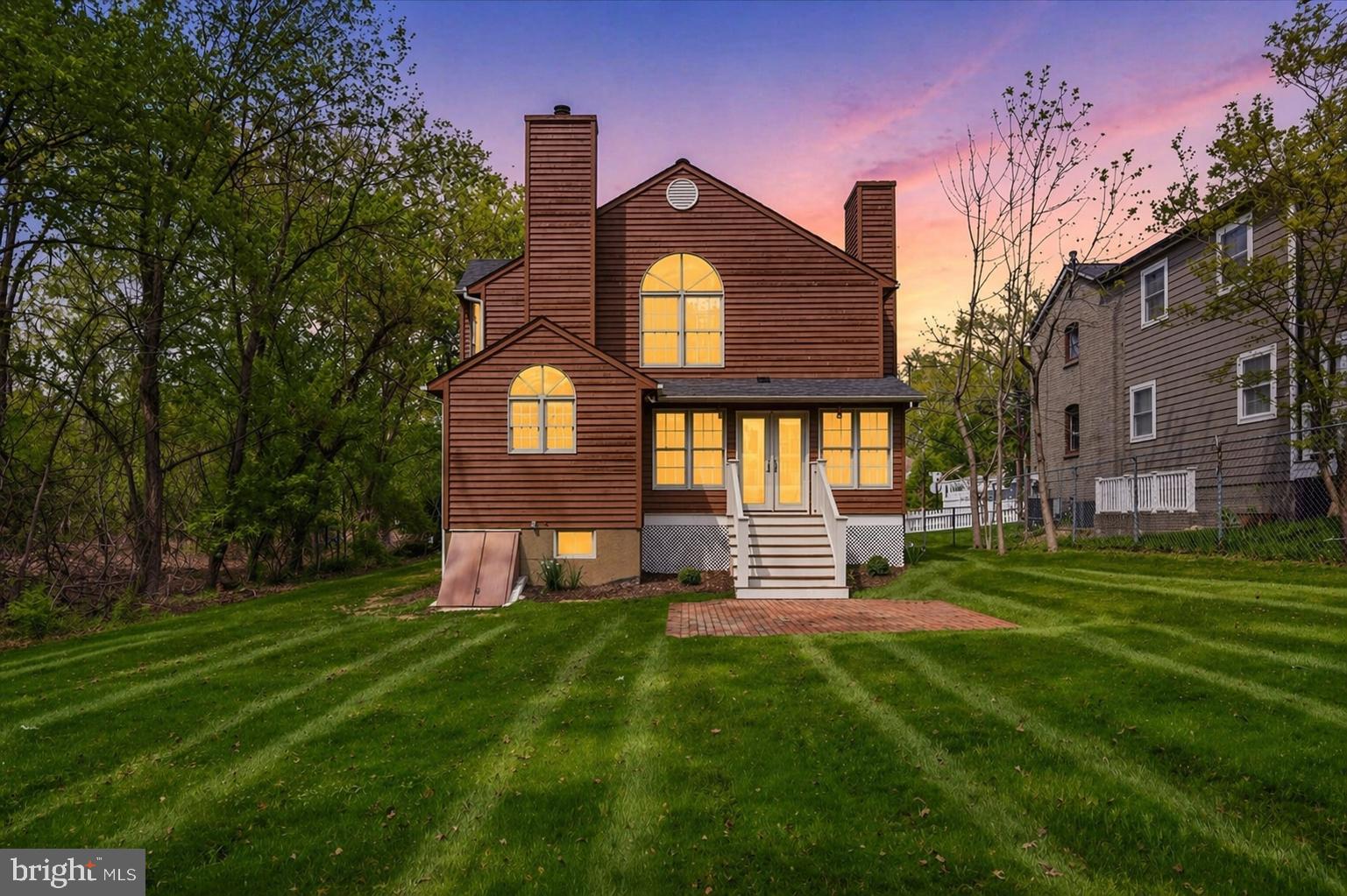 Back of house with large backyard adjacent park