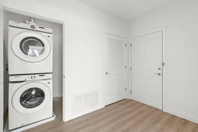 a view of a hallway with washer and dryer