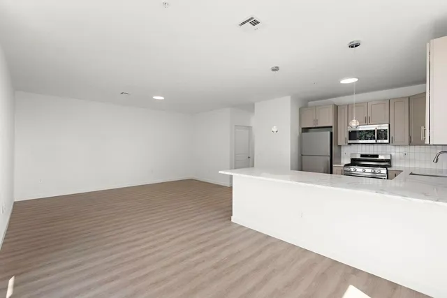a view of kitchen and wooden floor