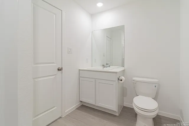 an empty room with a window and a ceiling fan