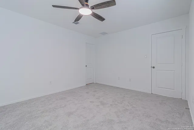 an empty room with a fan
