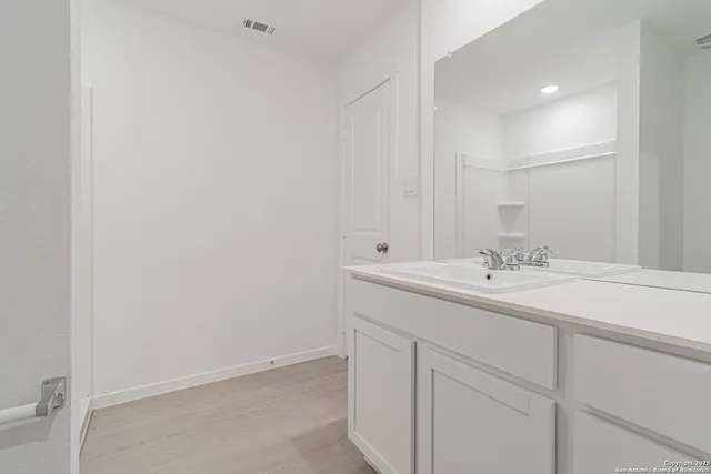 a view of a kitchen with a sink and a refrigerator