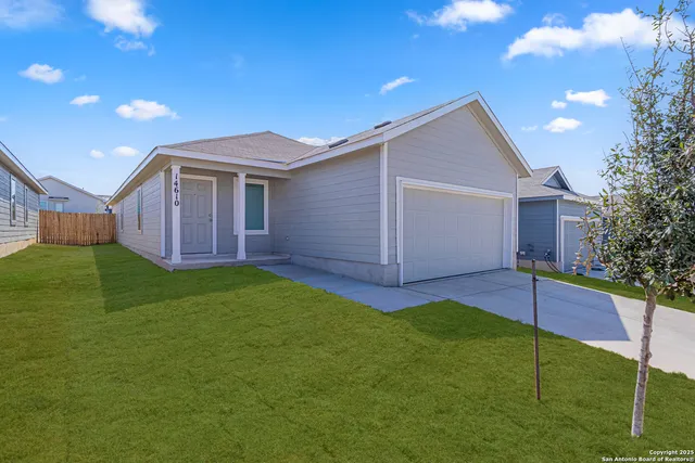 a view of a house with a backyard