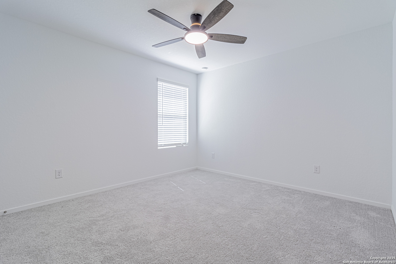 14610 Kayden Ridge San Antonio, TX 78253 - Photo 32 of 35 an empty room with a window and a ceiling fan