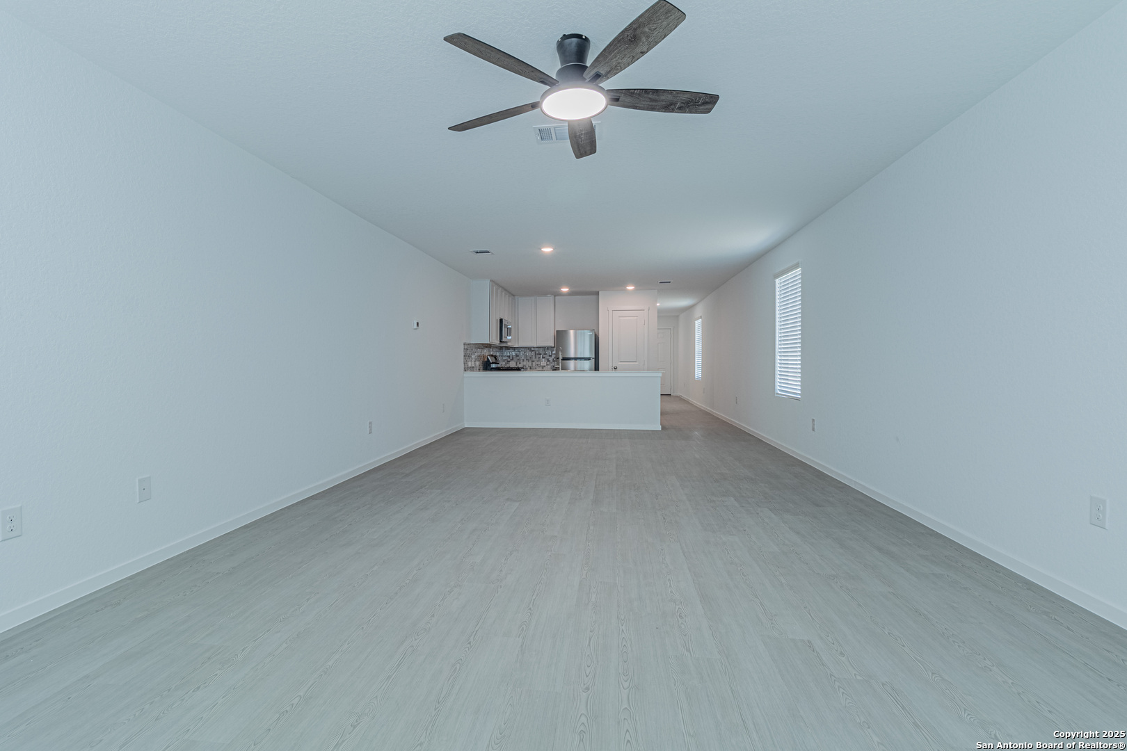 14610 Kayden Ridge San Antonio, TX 78253 - Photo 7 of 35 a view of a kitchen with a sink and a chandelier fan