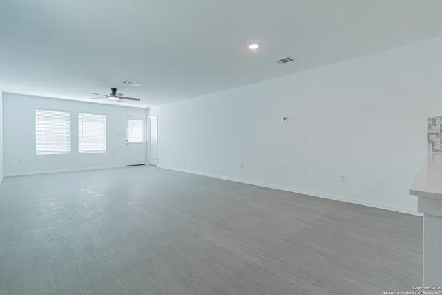 an empty room with windows and closet