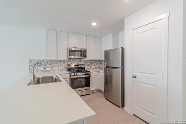 a kitchen with a refrigerator stove and microwave