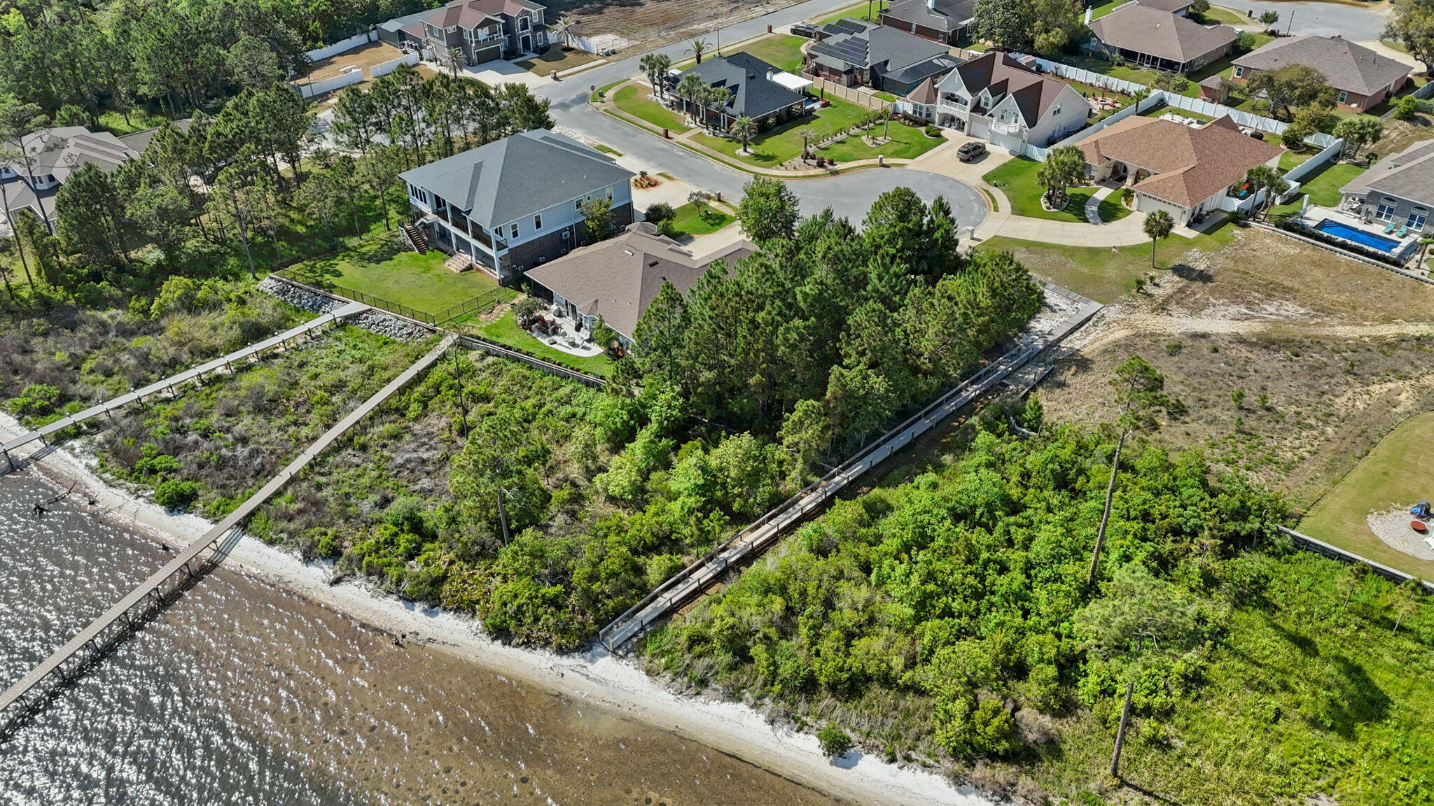 7475 Soundshore Drive Navarre, FL 32566 - Photo 16 of 35 an aerial view of a garden with houses