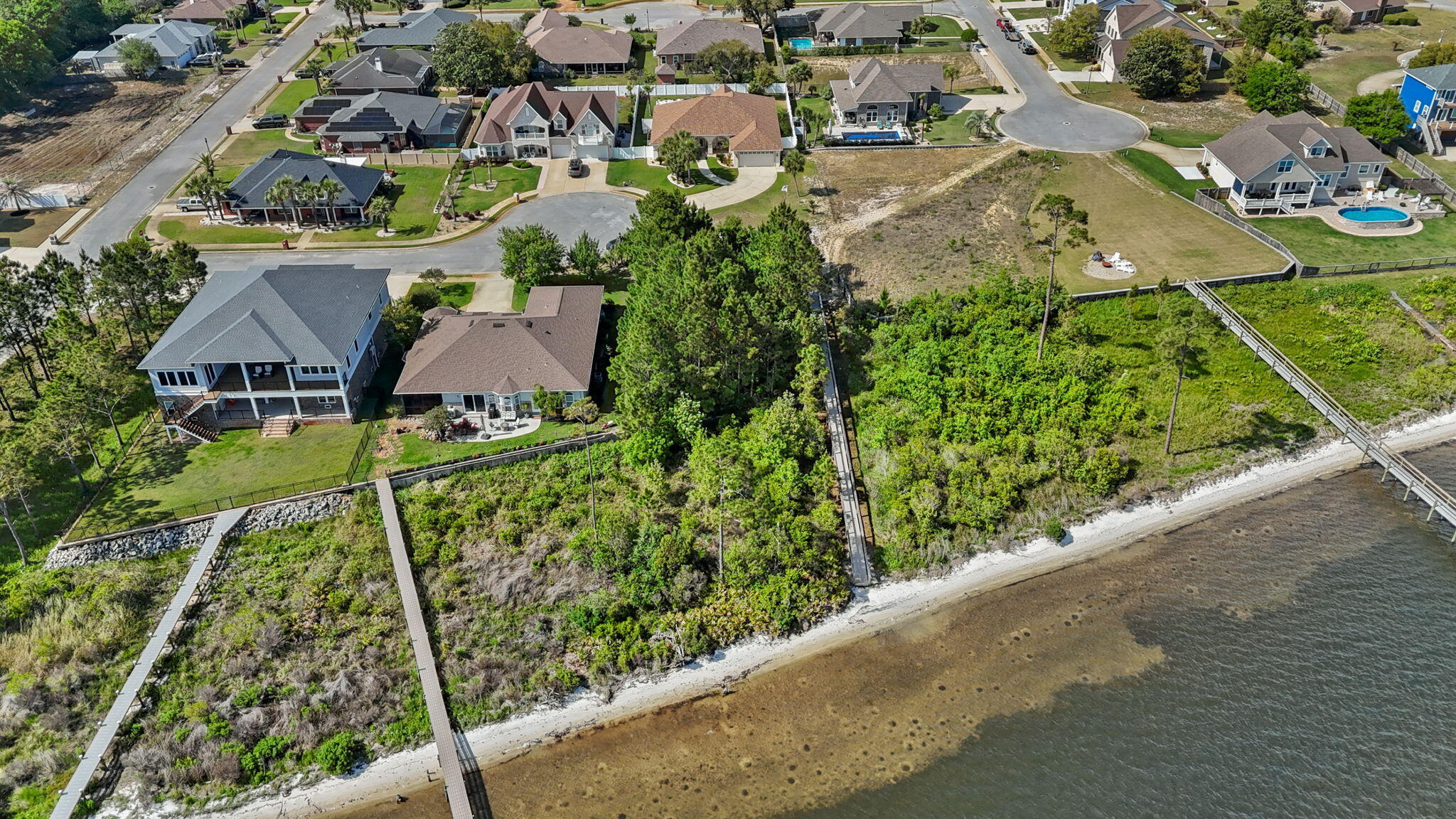 7475 Soundshore Drive Navarre, FL 32566 - Photo 18 of 35 an aerial view of residential houses with outdoor space