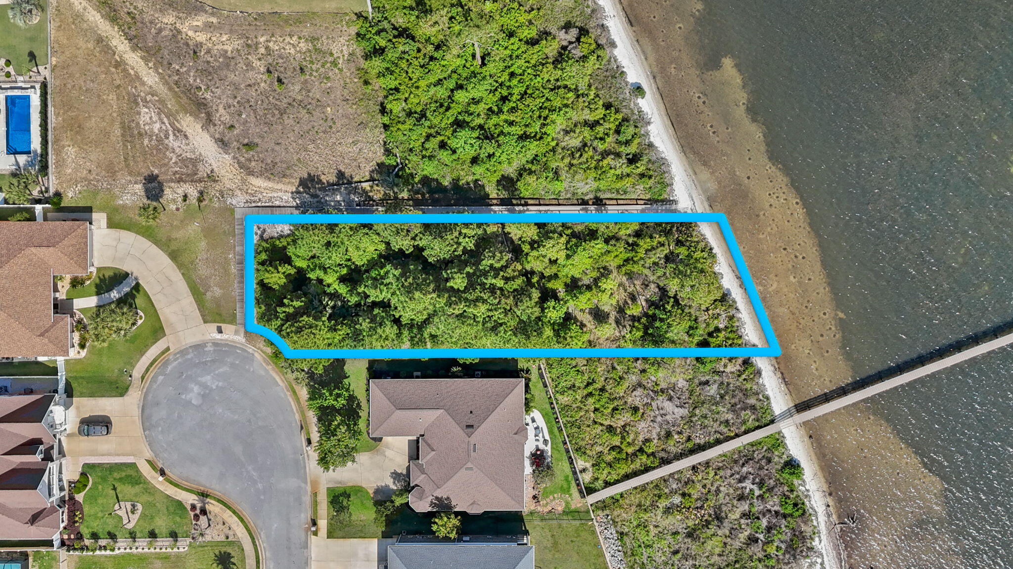 7475 Soundshore Drive Navarre, FL 32566 - Photo 9 of 35 an aerial view of a house with a garden