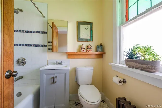a white toilet sitting next to a bathroom sink