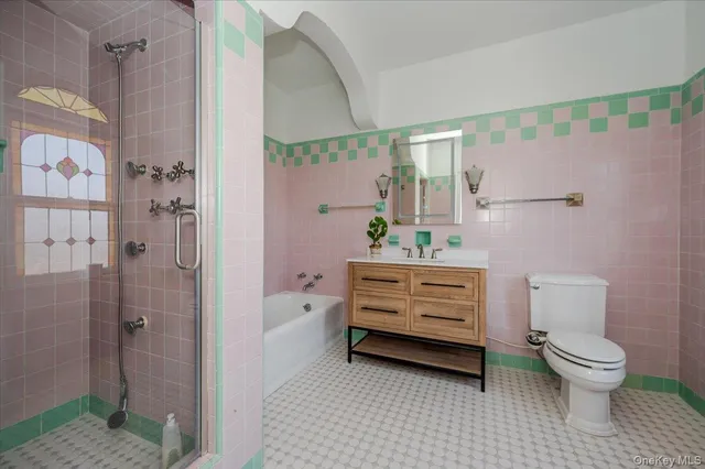 a bathroom with a sink a toilet and shower