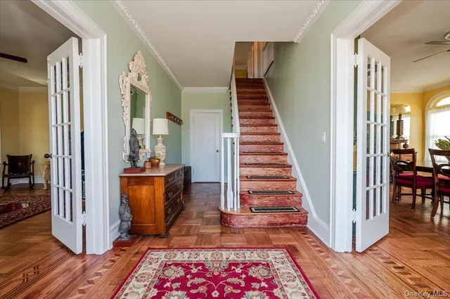 a view of entryway and hall with wooden floor