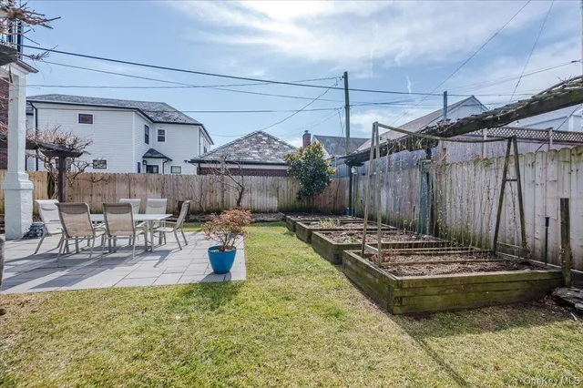 a view of a house with backyard porch and sitting area