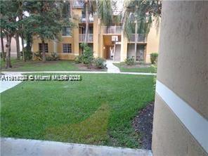 777 Southwest 111th Way, Unit 104 Pembroke Pines, FL 33025 - Photo 15 of 20 a view of a house with a big yard and large tree