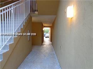 777 Southwest 111th Way, Unit 104 Pembroke Pines, FL 33025 - Photo 17 of 20 a view of a hallway with wooden floor