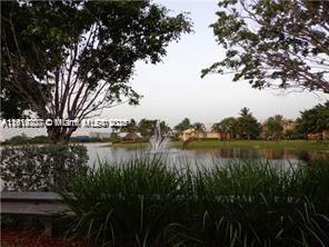 777 Southwest 111th Way, Unit 104 Pembroke Pines, FL 33025 - Photo 20 of 20 a view of lake with green space
