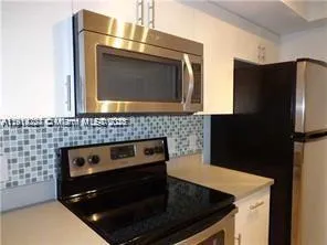 a kitchen with a stove microwave and refrigerator