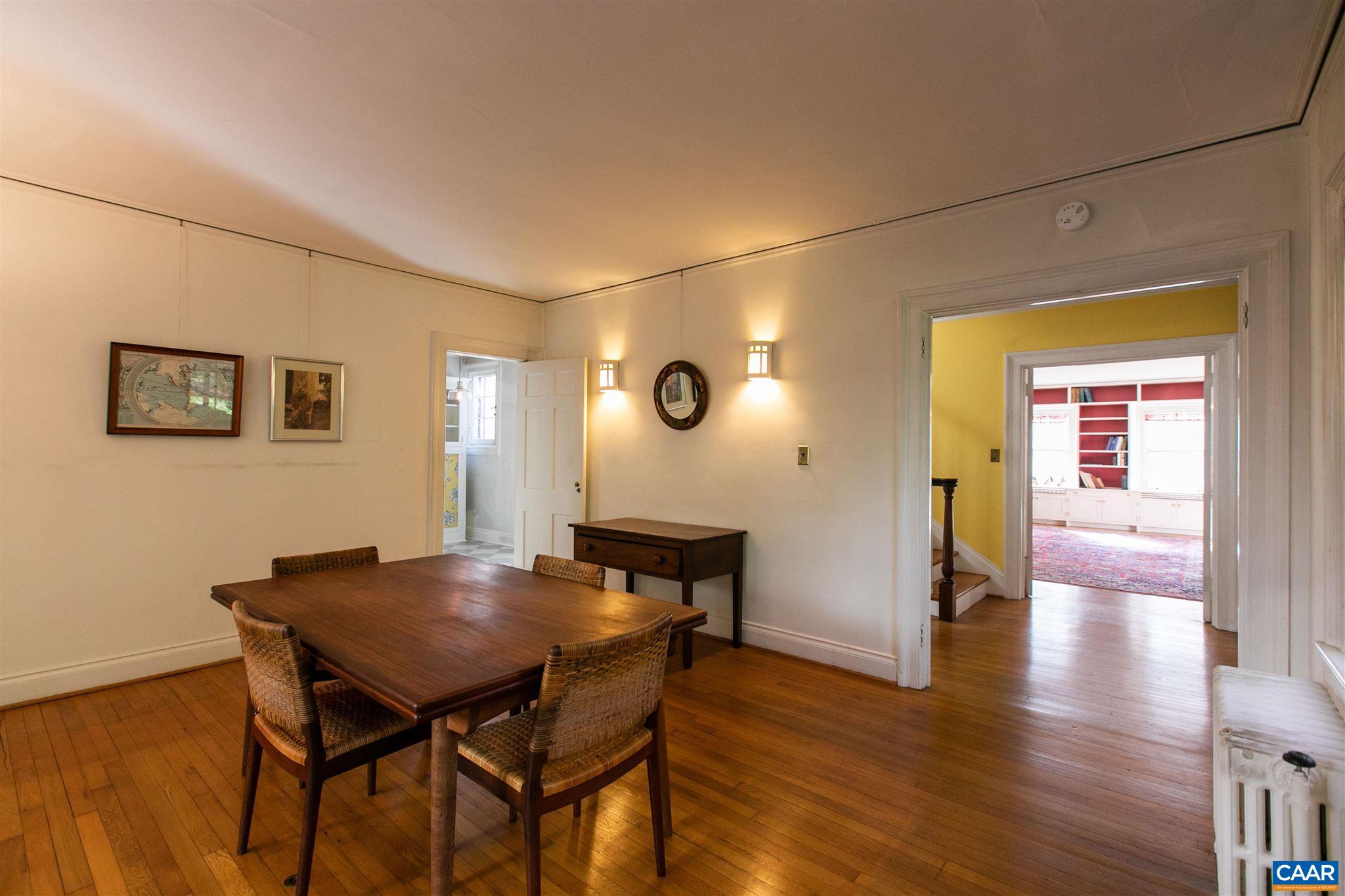 1102 Rugby Road Charlottesville, VA 22903 - Photo 15 of 51 a view of a dining room with furniture and wooden floor