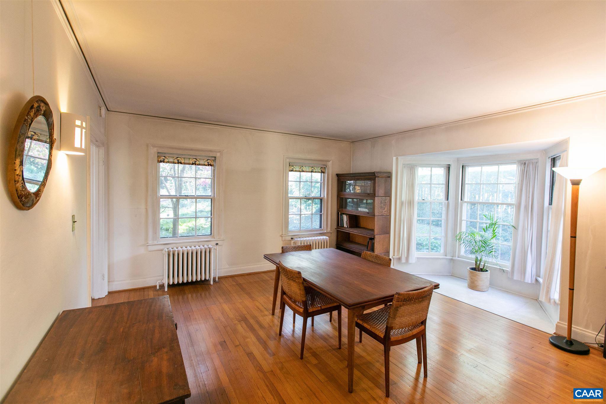1102 Rugby Road Charlottesville, VA 22903 - Photo 16 of 51 a view of a dining room with furniture and wooden floor