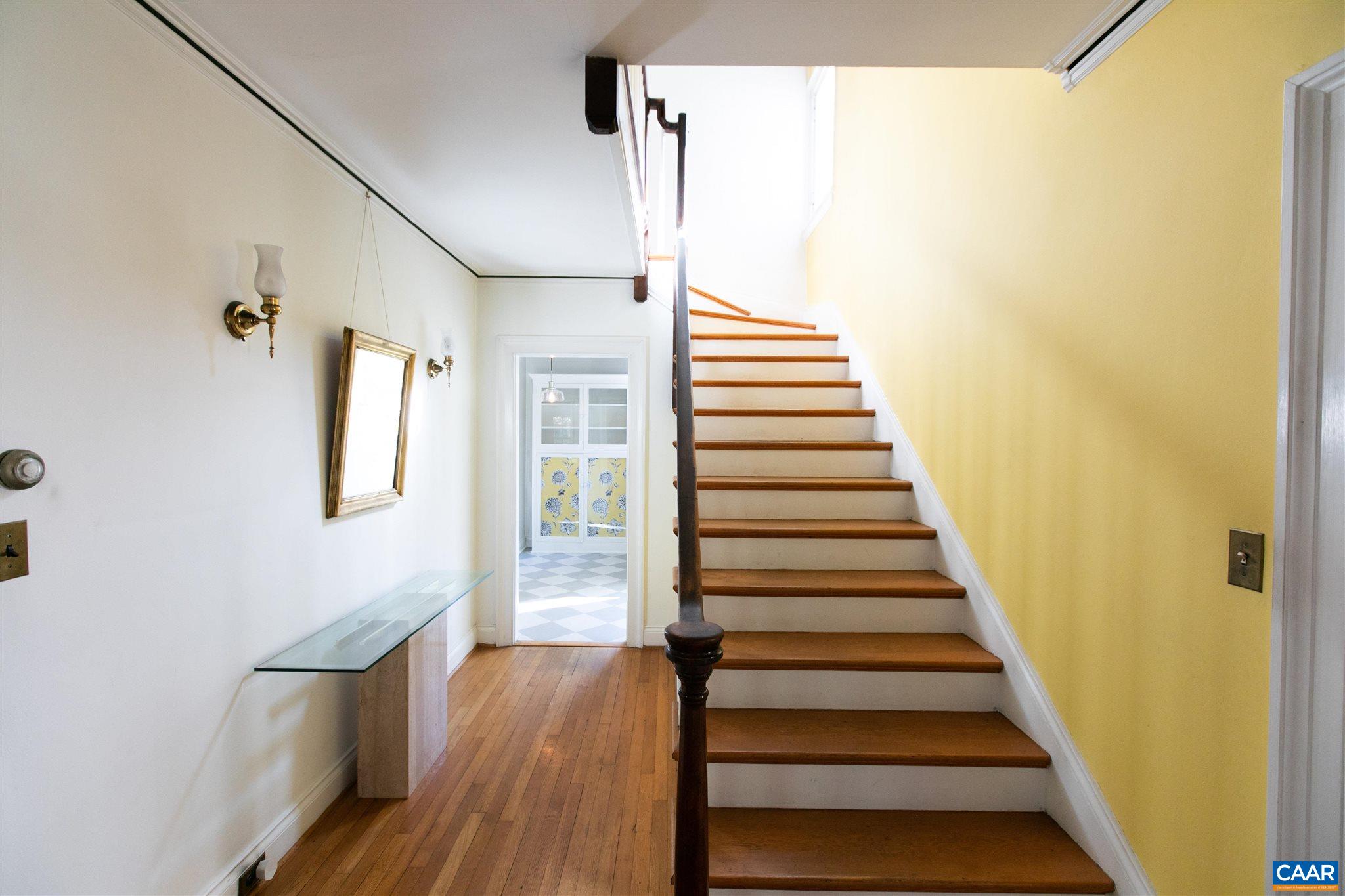 1102 Rugby Road Charlottesville, VA 22903 - Photo 3 of 51 a view of a hallway with wooden floor and staircase