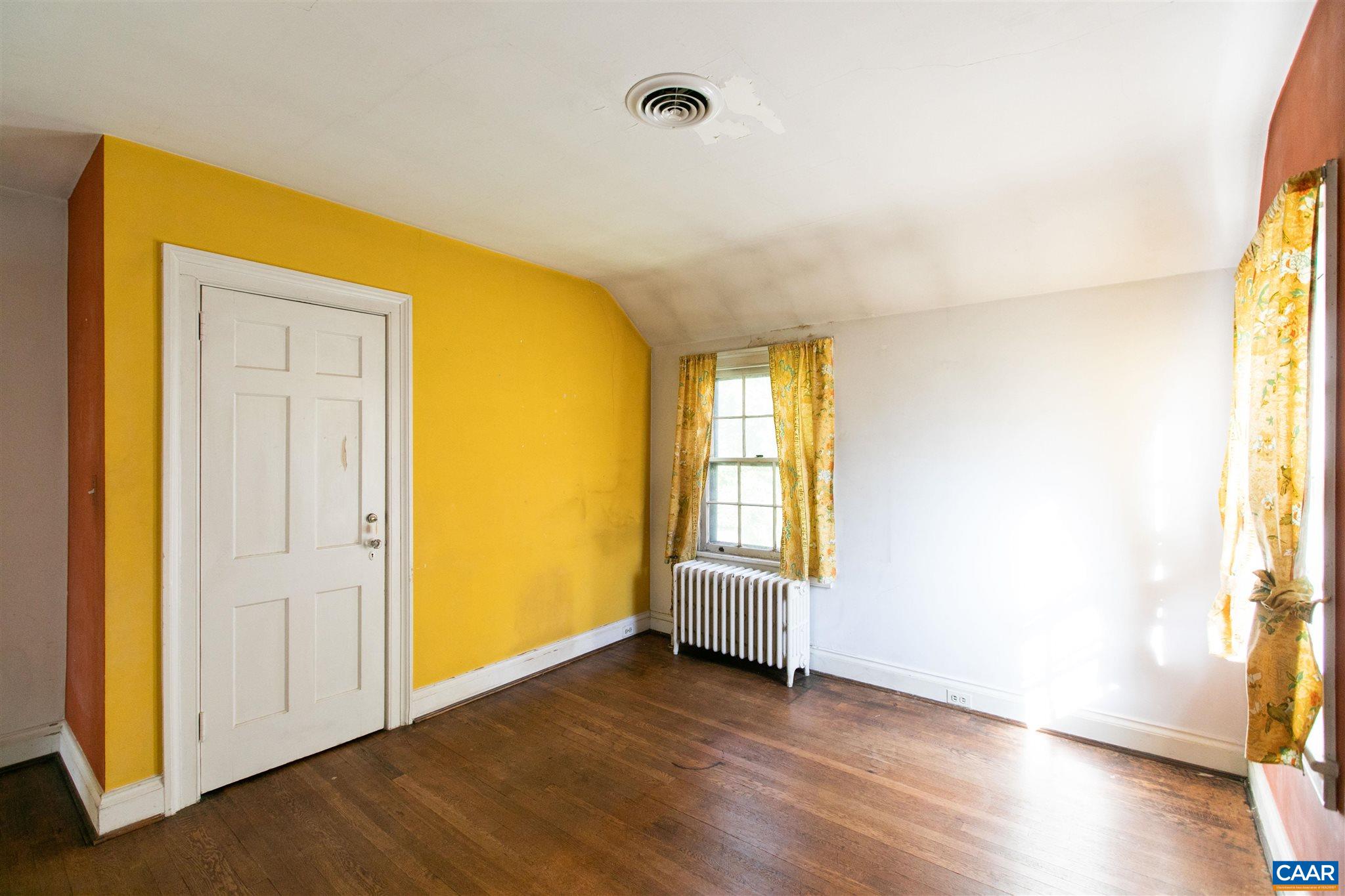 1102 Rugby Road Charlottesville, VA 22903 - Photo 38 of 51 an empty room with wooden floor and windows