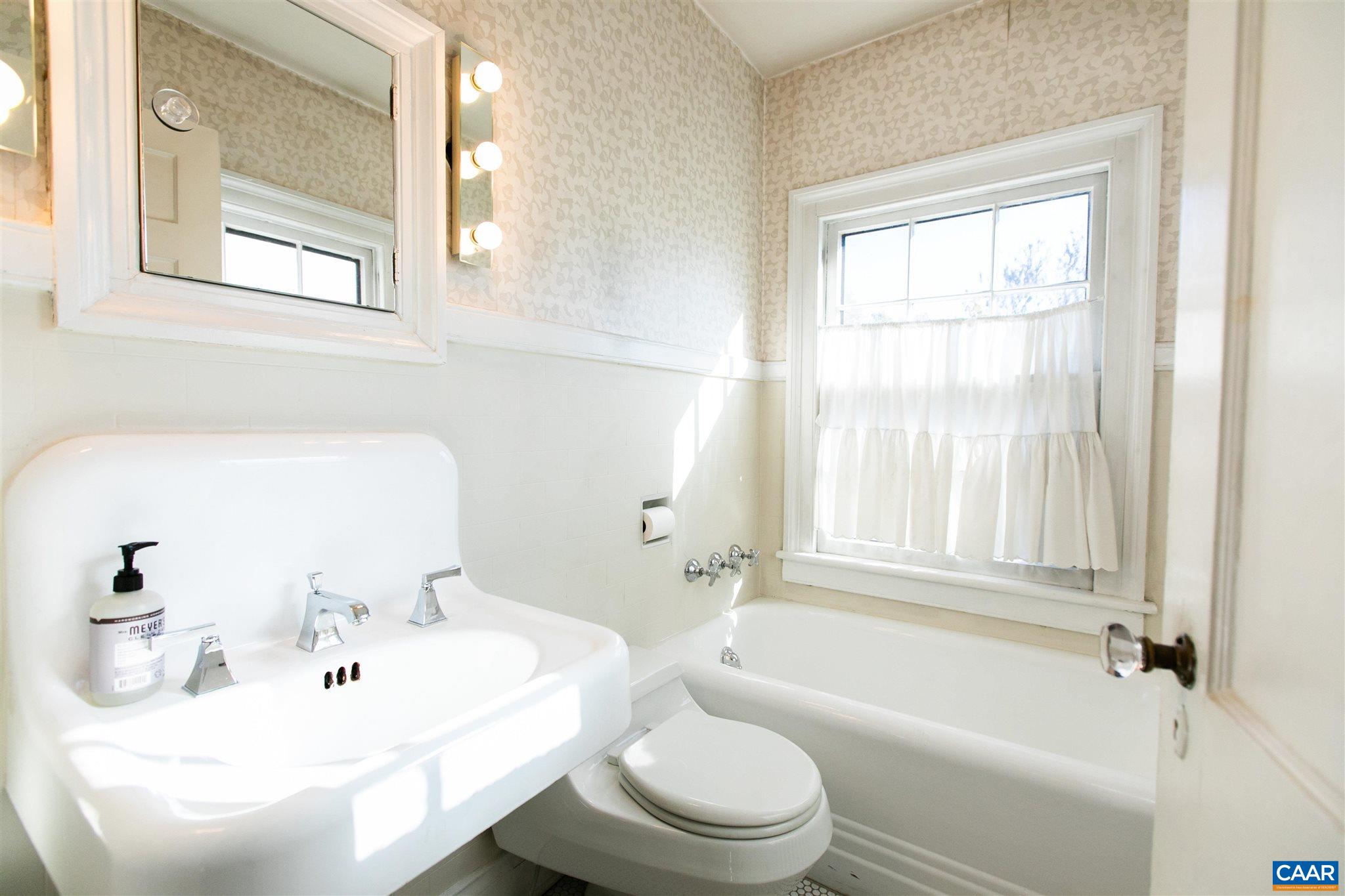 1102 Rugby Road Charlottesville, VA 22903 - Photo 44 of 51 a bathroom with a toilet a sink and a bathtub