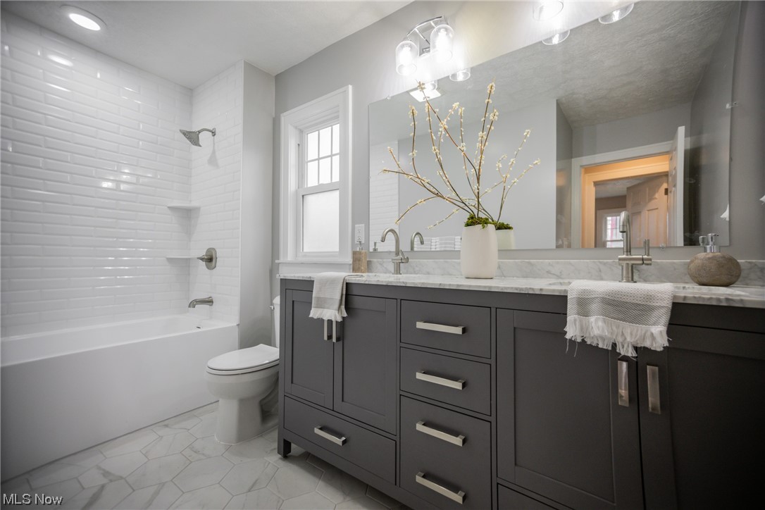 3553 Avalon Road Cleveland, OH 44120 - Photo 17 of 39 Full bathroom with tile floors, tiled shower / bath, toilet, and large vanity