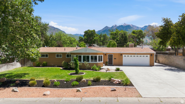 6889 South Village Road Salt Lake City, UT 84121 - Photo 1 of 44 Ranch-style residence featuring a prominent front lawn with established landscaping