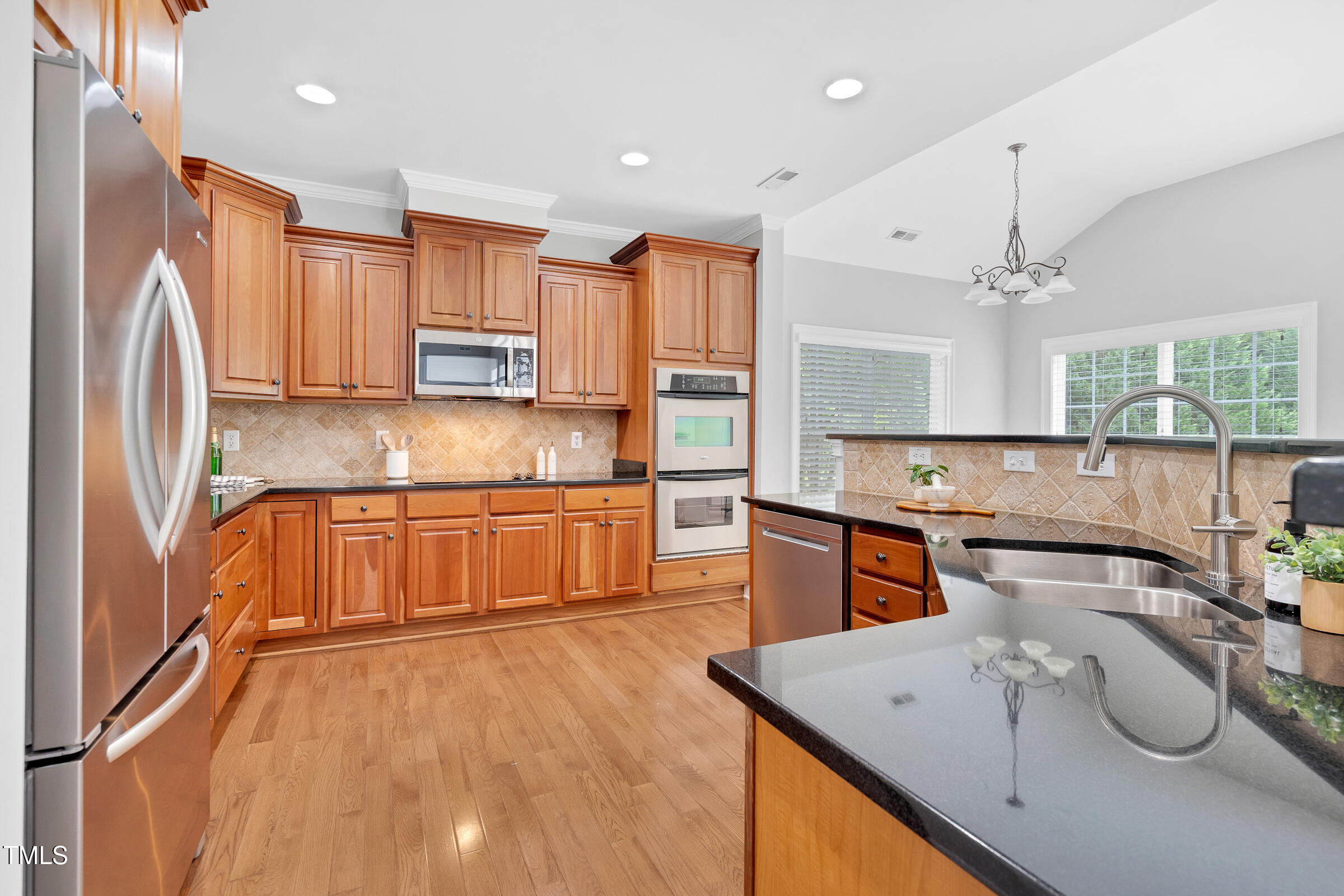 216 Creststone Drive Cary, NC 27519 - Photo 9 of 19 a kitchen with stainless steel appliances granite countertop a refrigerator a sink dishwasher a stove and white cabinets with wooden floor