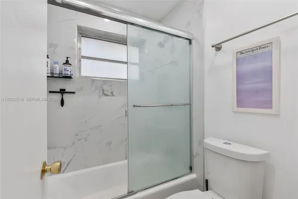 a bathroom with a shower and a toilet